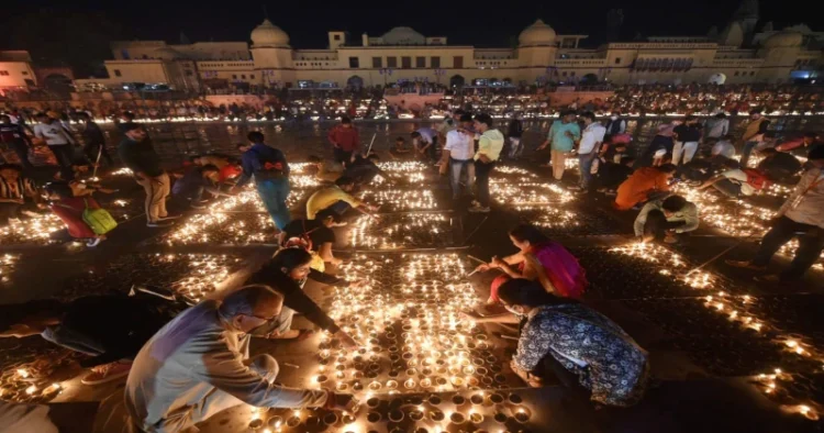 Devotees lighting diyas in Ayodhya