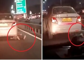 Screengrab from the viral video of the cab driver being dragged (India.Com)