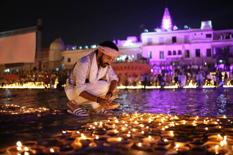A man lights an earthen lamp during Deepotsav celebrations in Ayodhya last year