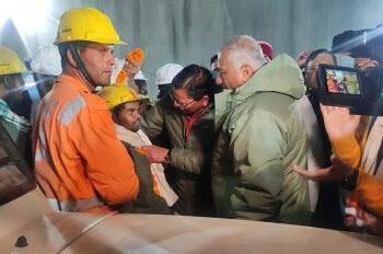 CM Dhami with the first worker who was taken out of the tunnel (ANI)