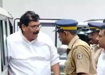 Congress leader KK Abraham along with a police official