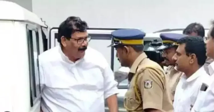 Congress leader KK Abraham along with a police official