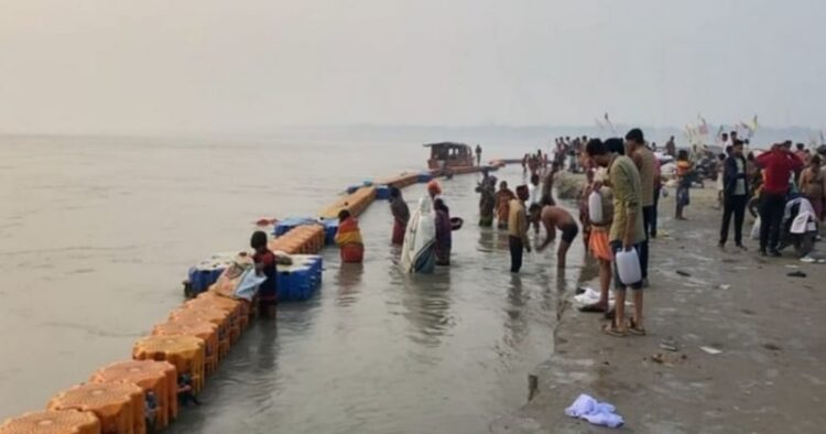 People take a dip at the confluence of the holy Ganga