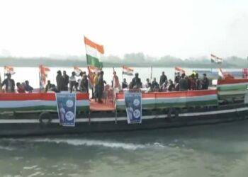 Rahul Gandhi, flanked by Congress leaders and workers, takes a boat ride across the Brahmaputra