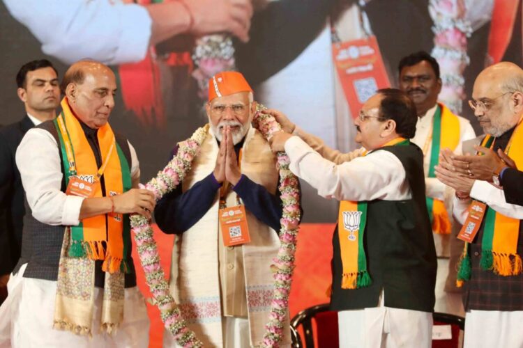 PM Modi with BJP party president JP Nadda and Defense Minister Rajnath Singh at Bharat Mandapam in party's National Convention (Image: BJP.org)