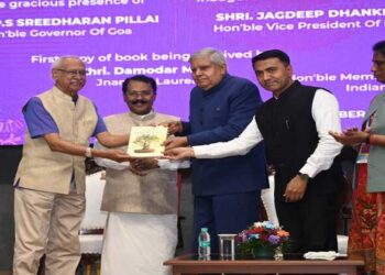 Damodar Mauzo receives the first copy from Vice President Jagdeep Dhankar