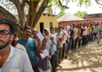 Voters standing in  queue  to cast their votes