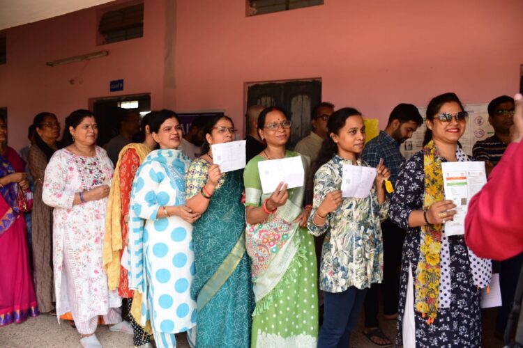 Female voters standing in que to cast their votes in Chhattisgarh