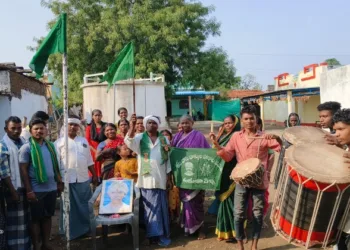 Tribals hoist flags at their village as a protest against Muslim attacks in Jainoor