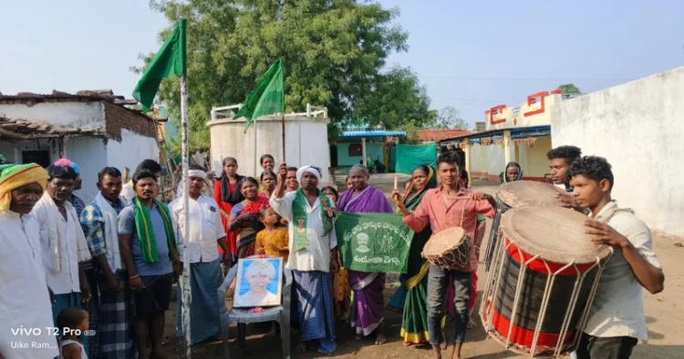 Tribals hoist flags at their village as a protest against Muslim attacks in Jainoor