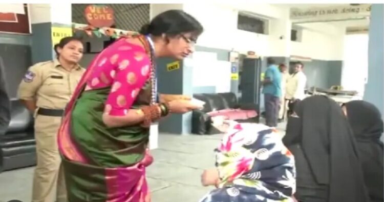 BJP candidate Madhavi Latha checking the voter id of the electorate