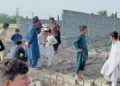 People gather outside the damaged school after militants’ set this government-run higher secondary school on fire in South Waziristan district on May 17, 2024. (Photo courtesy: District Police Wana)