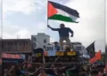 Youths waving Palestinian flags during a Muharram procession