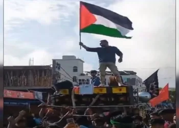 Youths waving Palestinian flags during a Muharram procession