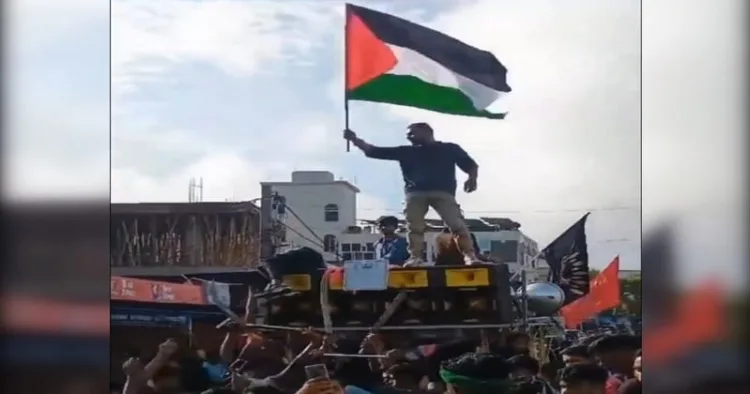 Youths waving Palestinian flags during a Muharram procession