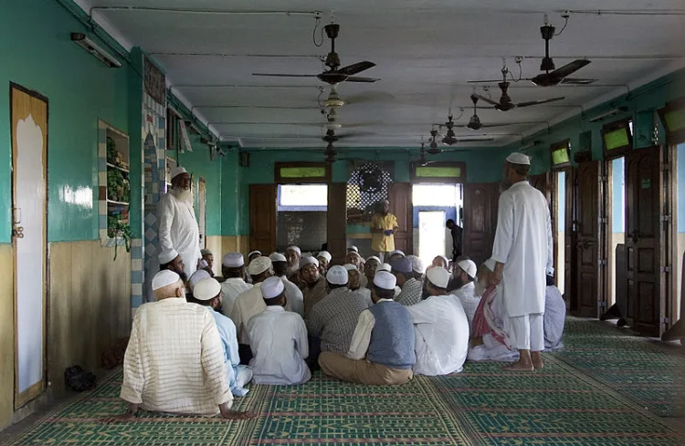 A representative image showing Muslim men gathered at a hall