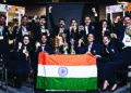 Chess players pose with their trophies after winning Gold in the women's open section and men's open event at Chess Olympiad 2024