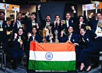 Chess players pose with their trophies after winning Gold in the women's open section and men's open event at Chess Olympiad 2024