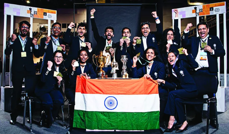 Chess players pose with their trophies after winning Gold in the women's open section and men's open event at Chess Olympiad 2024