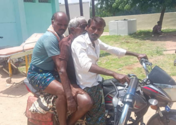 Sons of the deceased carrying his body on two wheeler after the  hospital refused to provide them with an ambulance