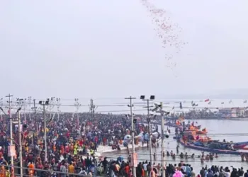 Image-4- Flower petals showered .... In order to make the experience of the devotees taking holy bath during Mahakumbh, flower petals were showered on them from the helicopter