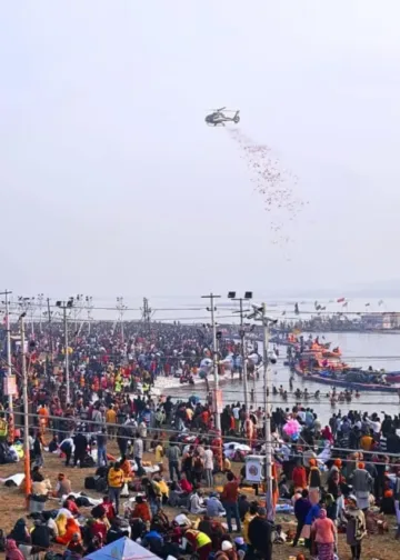 Image-4- Flower petals showered .... In order to make the experience of the devotees taking holy bath during Mahakumbh, flower petals were showered on them from the helicopter