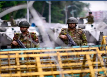 Bangladesh army personnel standing behind the barricades