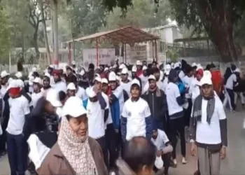 People participating in a walkathon ahead of Mahakumbh 2025