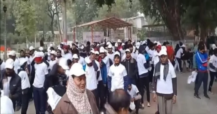 People participating in a walkathon ahead of Mahakumbh 2025