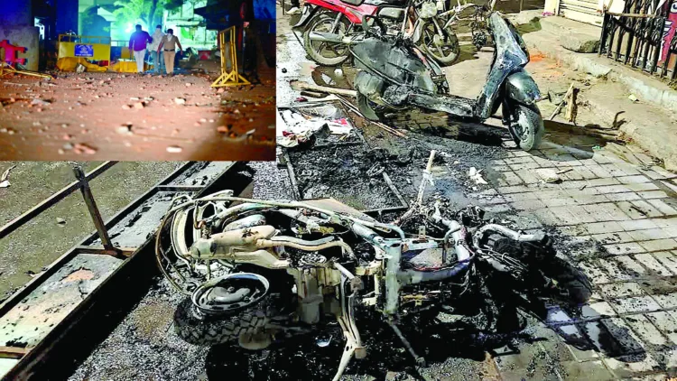 Charred remains of a vehicle is seen after a clash broke out between two groups at Hansapuri area in Nagpur on March 17