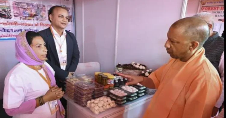 UP CM Yogi Adityanath interacting with a woman selling products of her district as part of ODOP initiative of UP govt