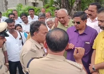 Police officials and parents outside the CET exam centre where the officials forcibly removed the Janivara of the candidates