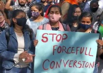 Women holding posters asking to stop forceful conversion