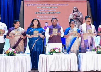 CM Mohan Majhi and other dignitaries releasing an book on Ahilyabai Holkat during the program.