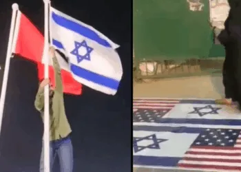 Zakir, a bike mechanic in Hyderabad, removing Israeli national flag