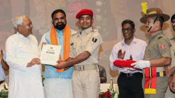 Bihar Chief Minister Nitish Kumar hands over an appointment letter to a newly recruited constable of Bihar Police, at Bapu Auditorium in Patna on Saturday. State Deputy Chief Minister Samrat Chaudhary also seen. (ANI Photo)