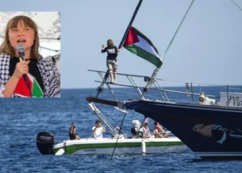 Left activist Greta Thunberg stands near a Palestinian flag after boarding the Madleen boat in Sicily on June 1