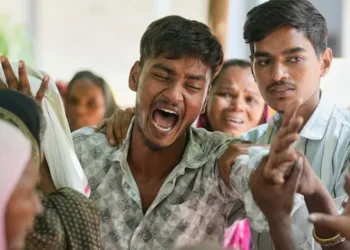 With bodies charred beyond recognition, grieving families wait with DNA samples, hoping for a name, a match