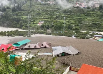 Damaged structures and muddy landscape in Uttarkashi after the cloudburst and flash floods demonstrate the disaster's impact and need for coordinated rescue efforts