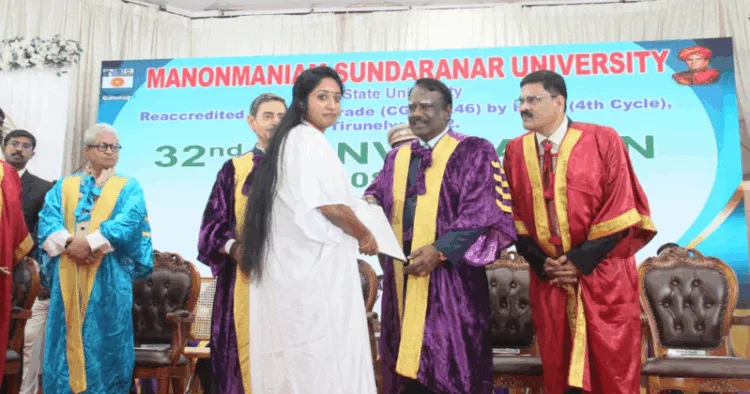 PhD scholar Jean Joseph receiving doctarate from VC, Governor RN Ravi on stage.