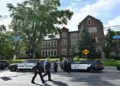 The Police officials of Minneapolis undertake investigation in the premises of Annunciation Catholic Church after an unidentified gunmen opened fie at the school children leading to the death of two children and 17 others injured