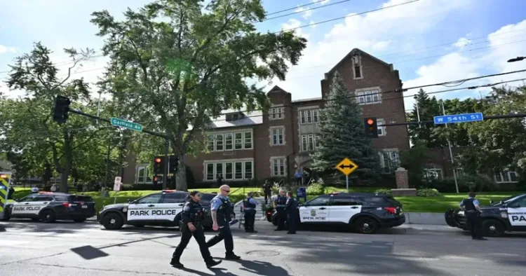 The Police officials of Minneapolis undertake investigation in the premises of Annunciation Catholic Church after an unidentified gunmen opened fie at the school children leading to the death of two children and 17 others injured