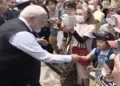 PM Narendra Modi greets children and others in Japan
