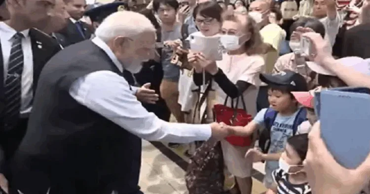 PM Narendra Modi greets children and others in Japan