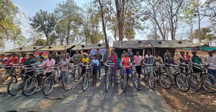 Security personnel with villagers during a civic action program in Bastar