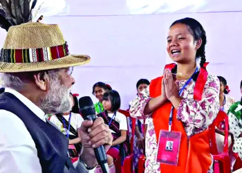 Prime Minister Narendra Modi greeted by a girl at a public meeting at Imphal