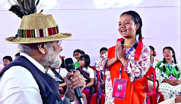 Prime Minister Narendra Modi greeted by a girl at a public meeting at Imphal