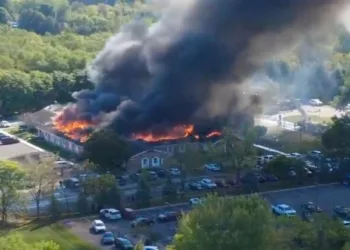 Massive flames and thick smoke rise from the church building in Grand Blanc, Michigan
