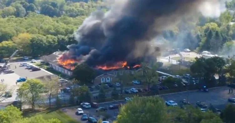 Massive flames and thick smoke rise from the church building in Grand Blanc, Michigan