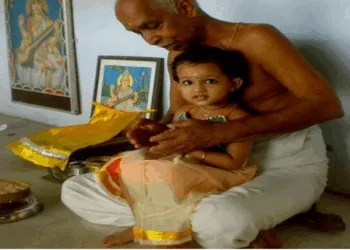 A child in the lap of acharya